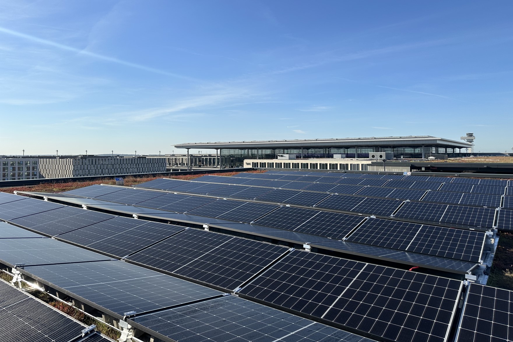 Photovoltaic systems on a roof. The sky is blue.