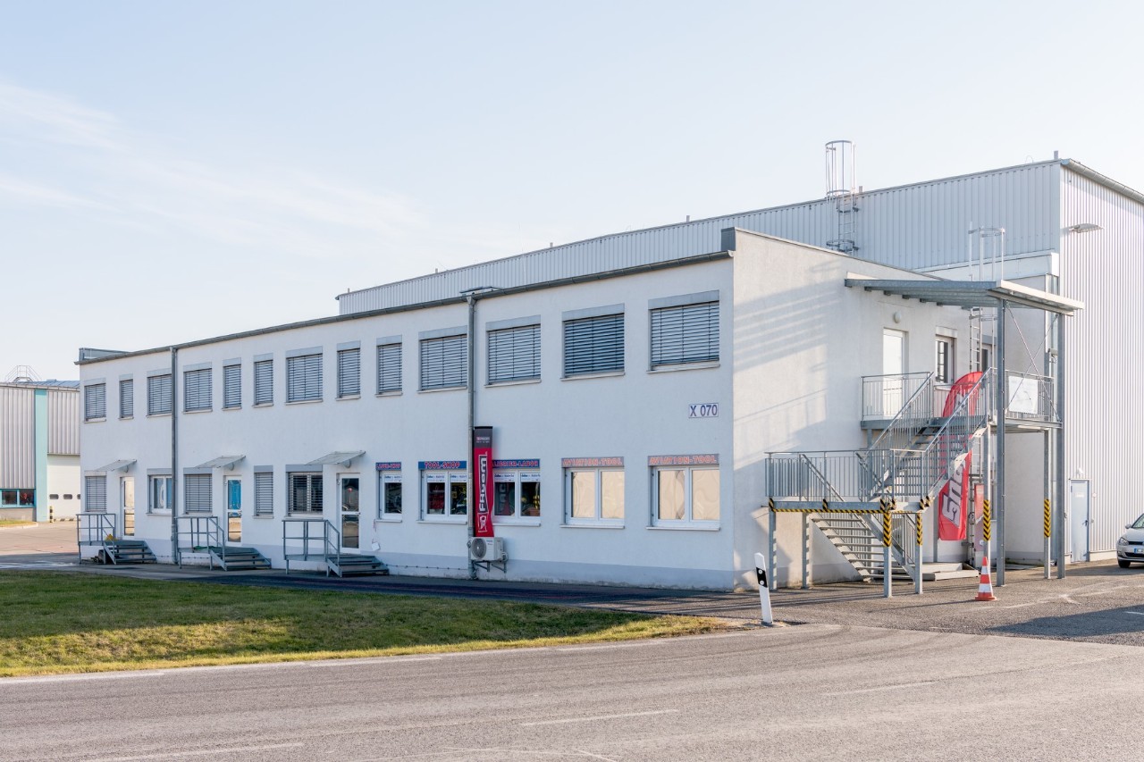 A white building. A street in front of it.