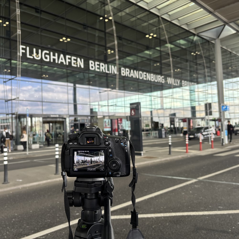 Camera in front of an airport terminal