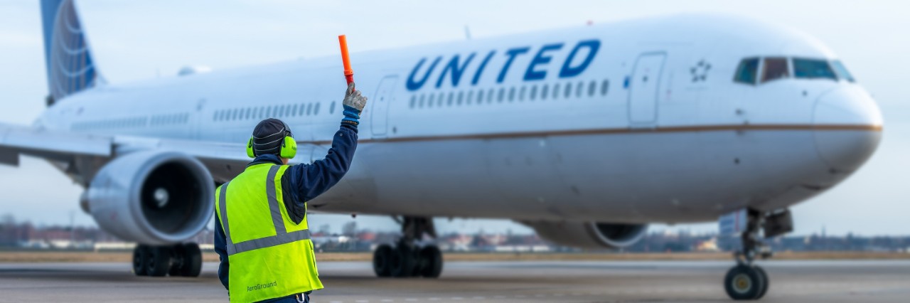 United Airlines aircraft being marshalled in