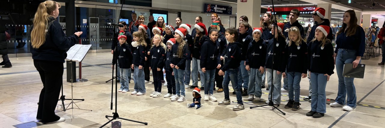 a group of children performing christmas songs