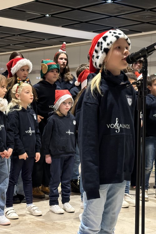 a group of children performing christmas songs