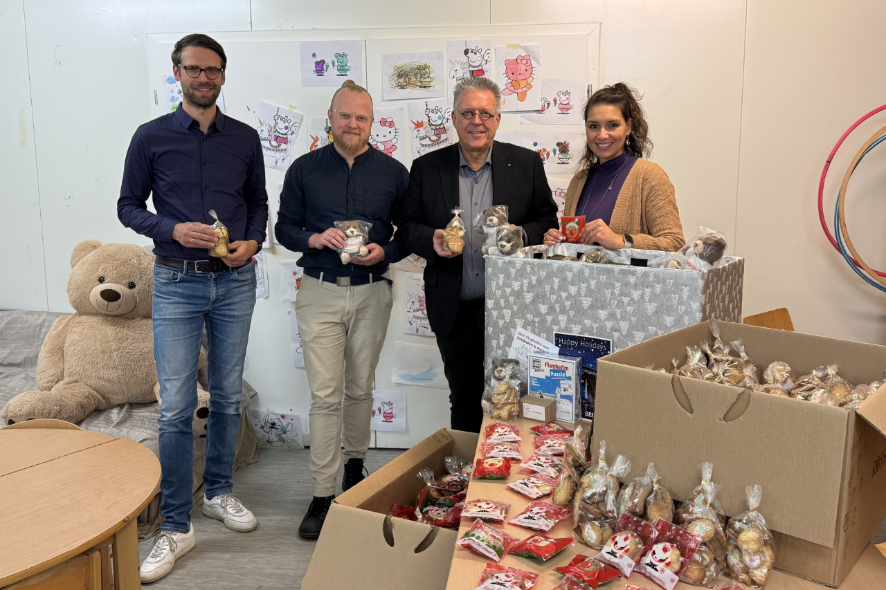 Four people with biscuits in their hands