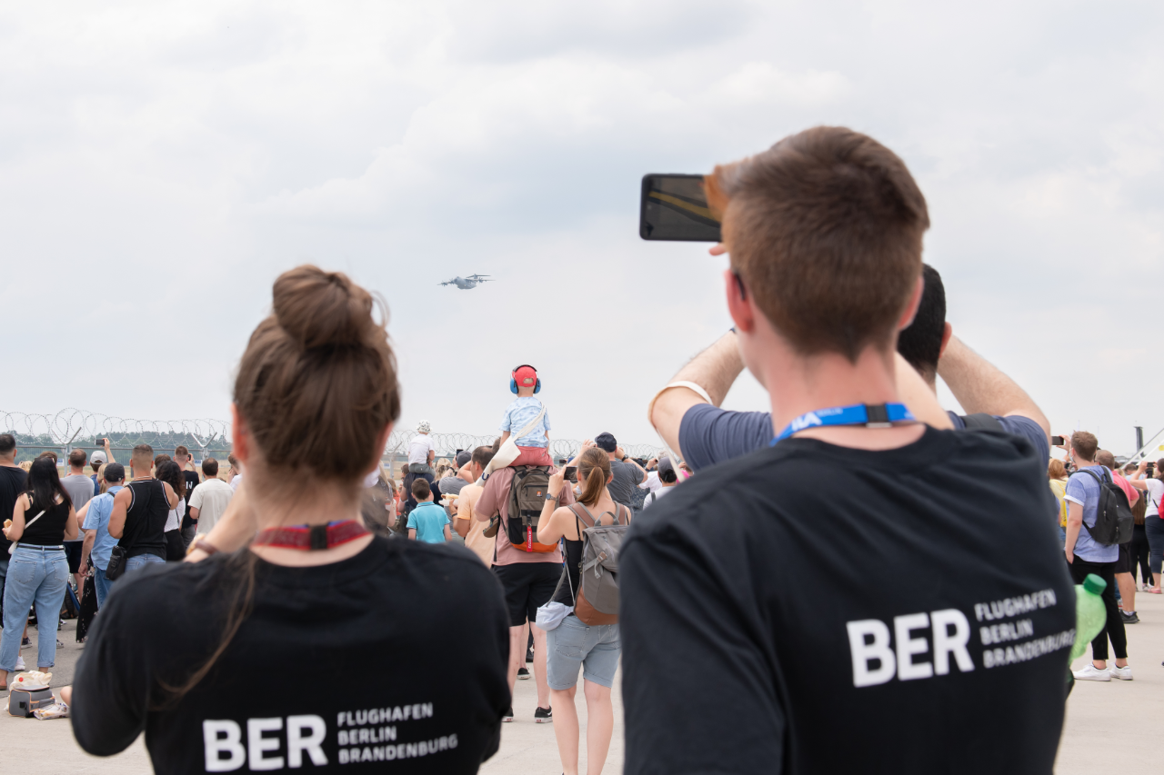 Visitors watch the air show at the ILA
