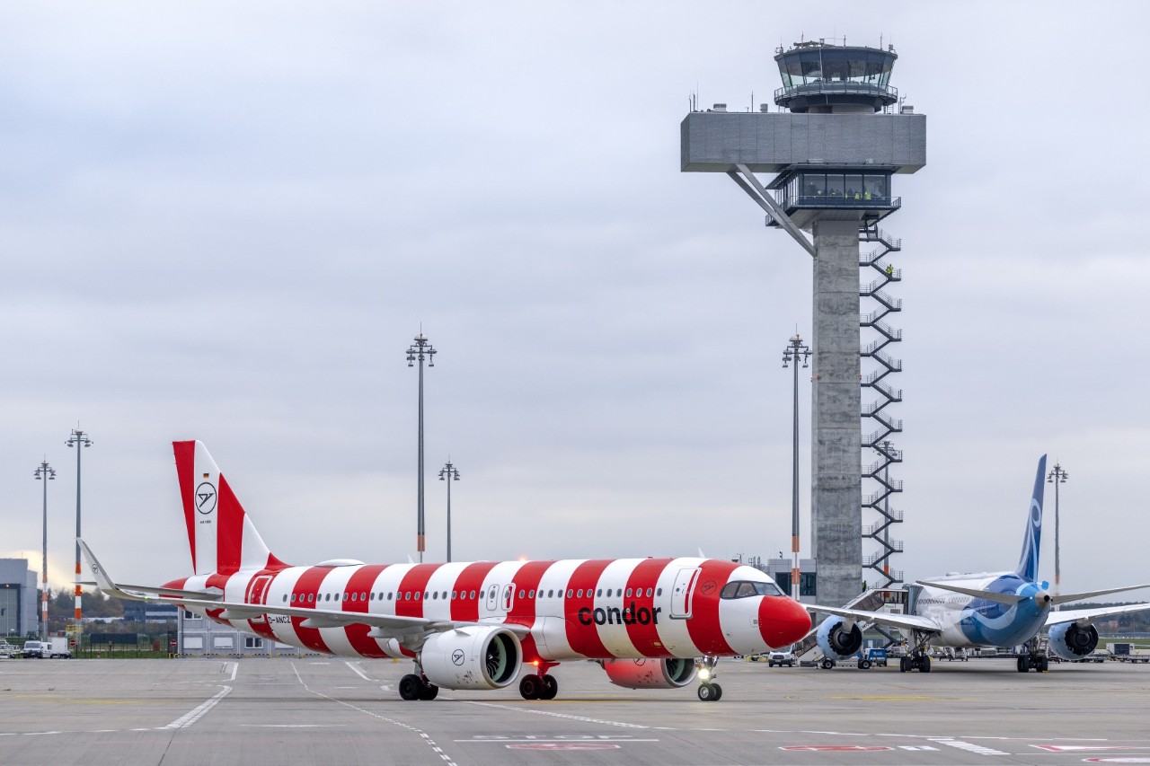Condor aircraft in front of the BER tower