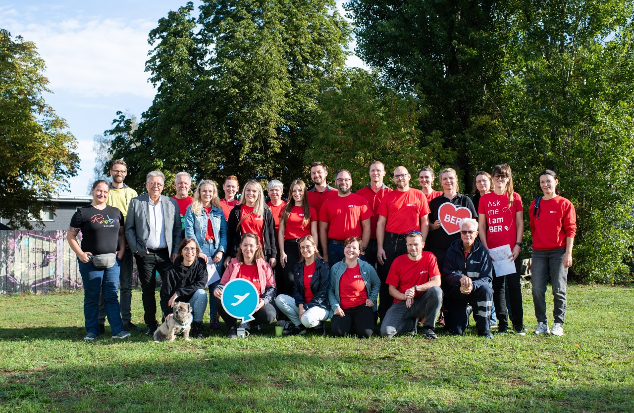 A group of people in red shirts on a field