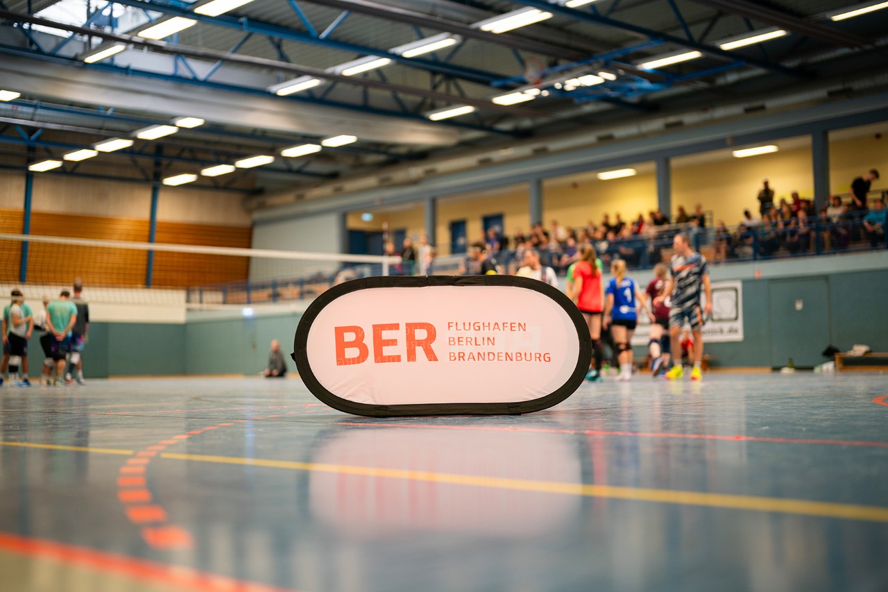 The BER logo on a volleyball court